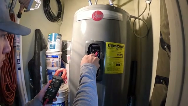 Micah inspecting a Rheem water heater in Lampasas TX with a clamp meter